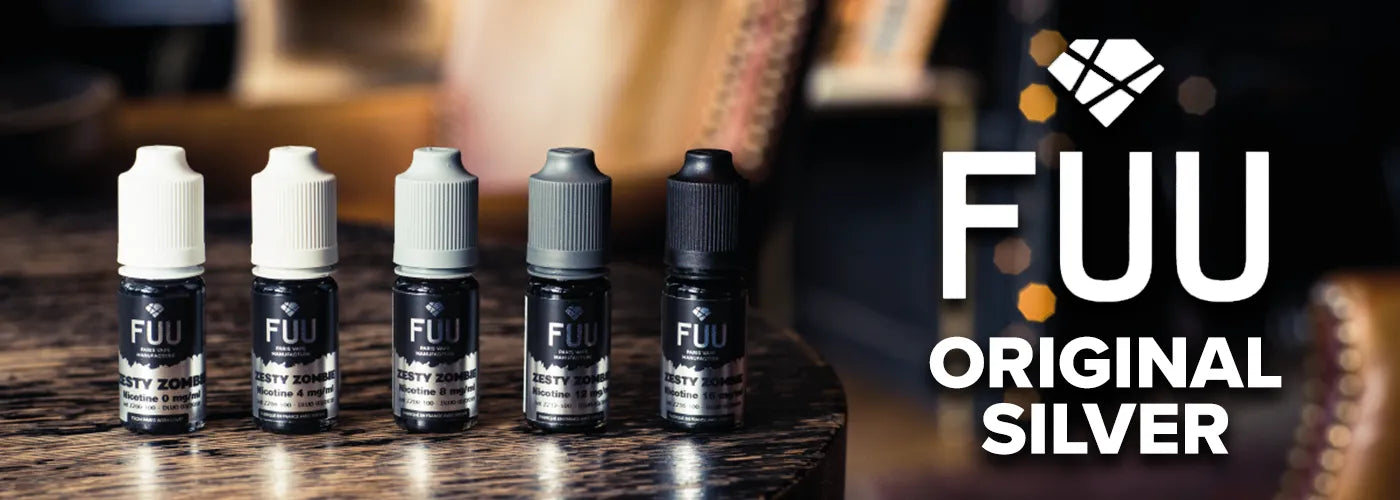 Five 10ml bottles of Fuu Original Silver e-liquid stood on a dark wooden table on the left, with the Fuu Original Silver logo in white on the right.